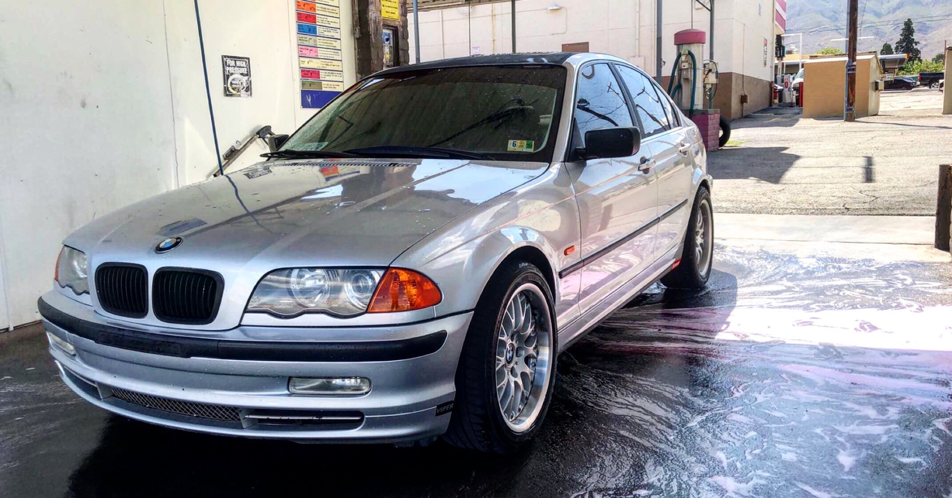 Silver BMW E46 3 Series at a car wash