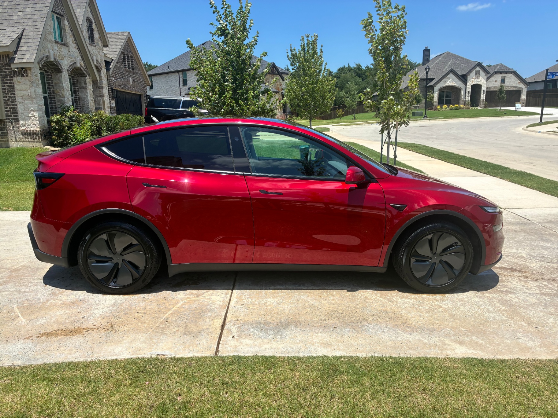 Red Tesla Model Y side profile after detailing