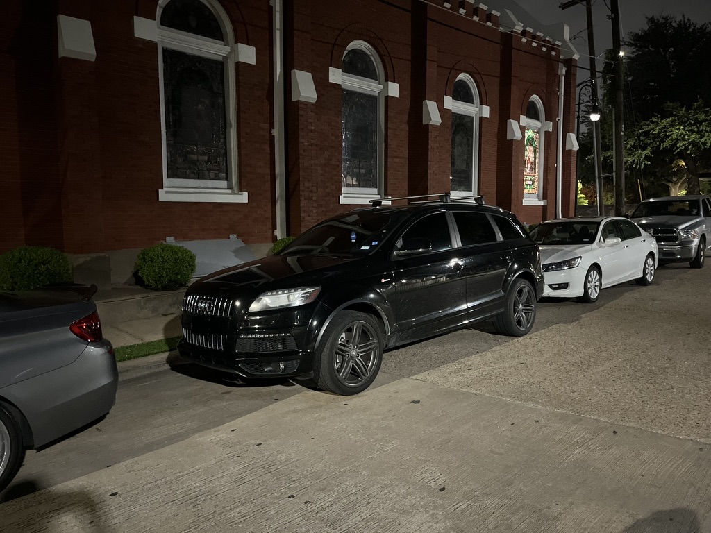 Black Audi Q7 SUV parked on a street at night