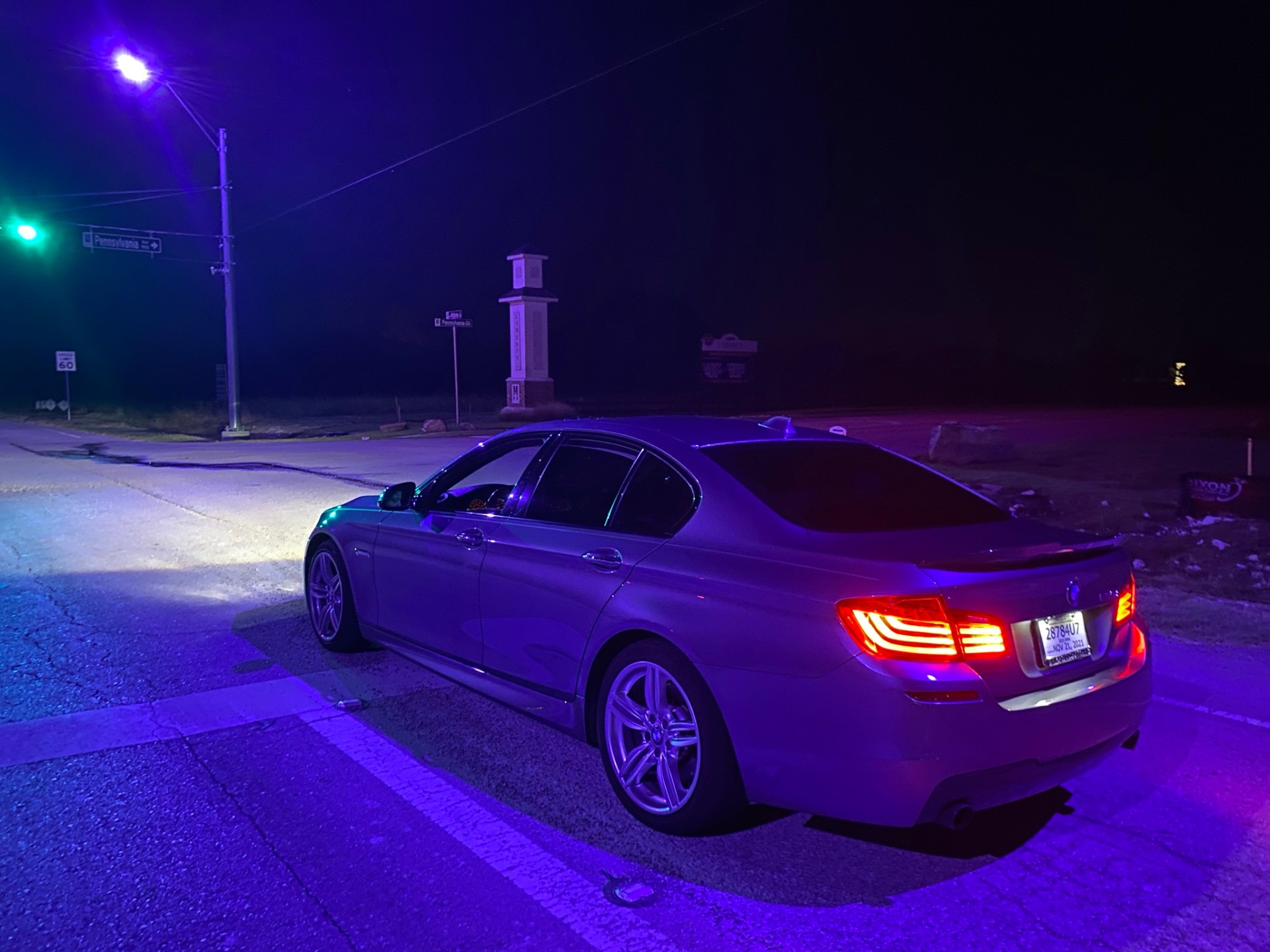 BMW 5 Series at night under street lights