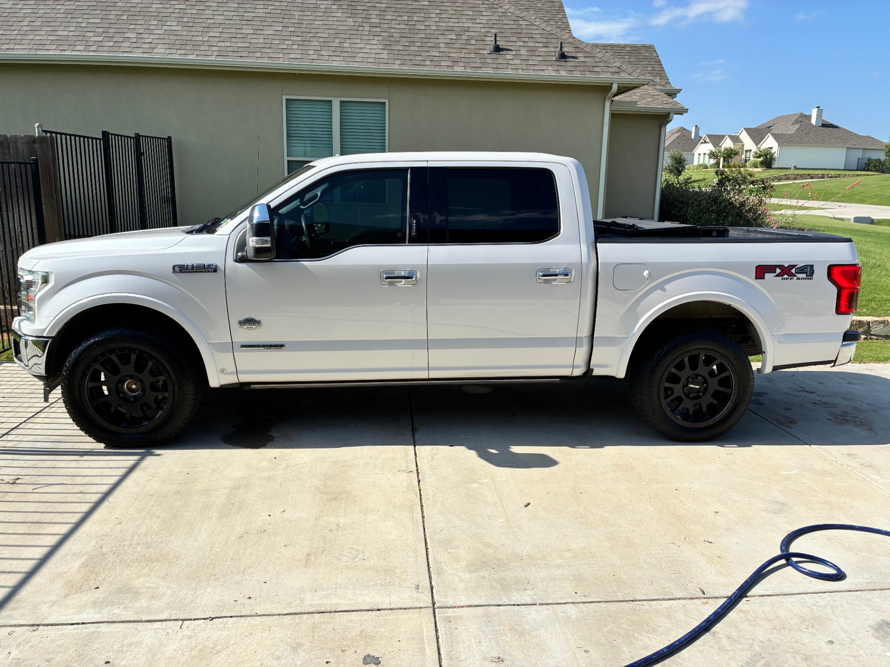 White Ford F-150 King Ranch side profile after detailing