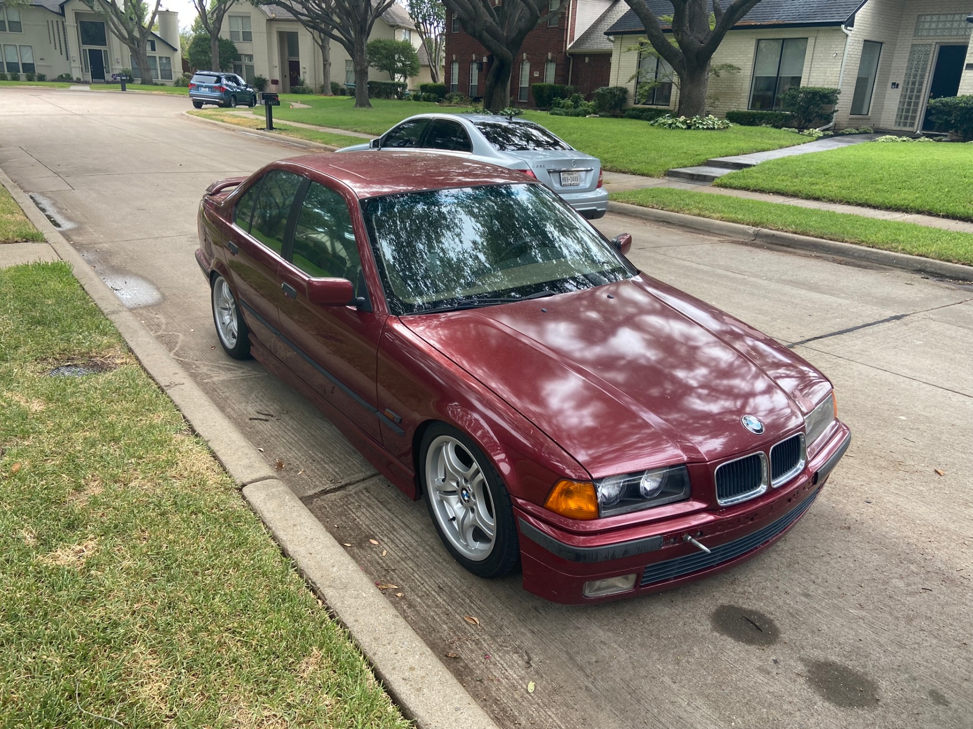 Red BMW E36 3 Series parked on the street