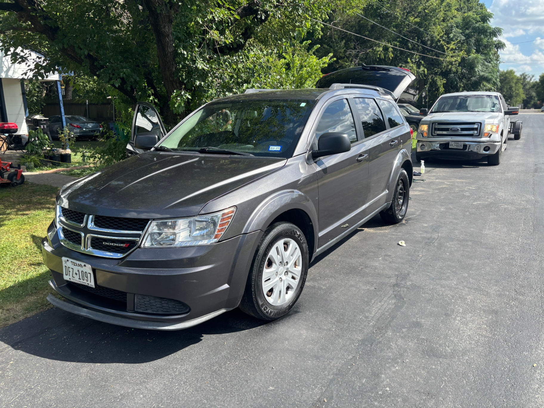Grey Dodge Journey exterior after wash in the driveway