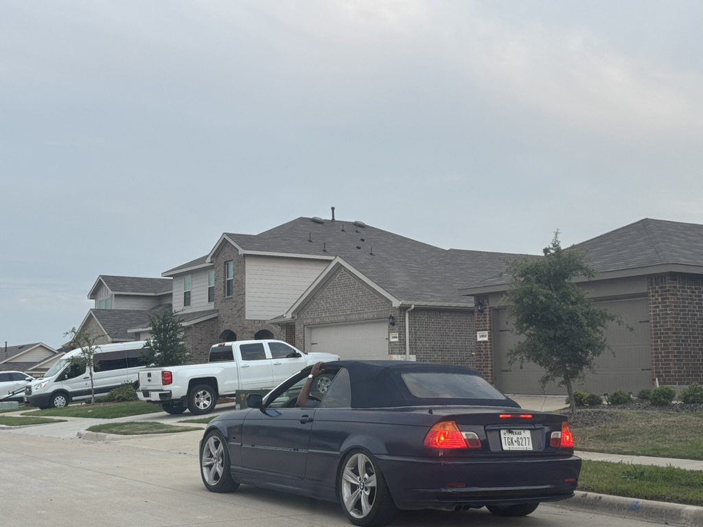 Dark blue BMW 3 Series convertible parked on a suburban street