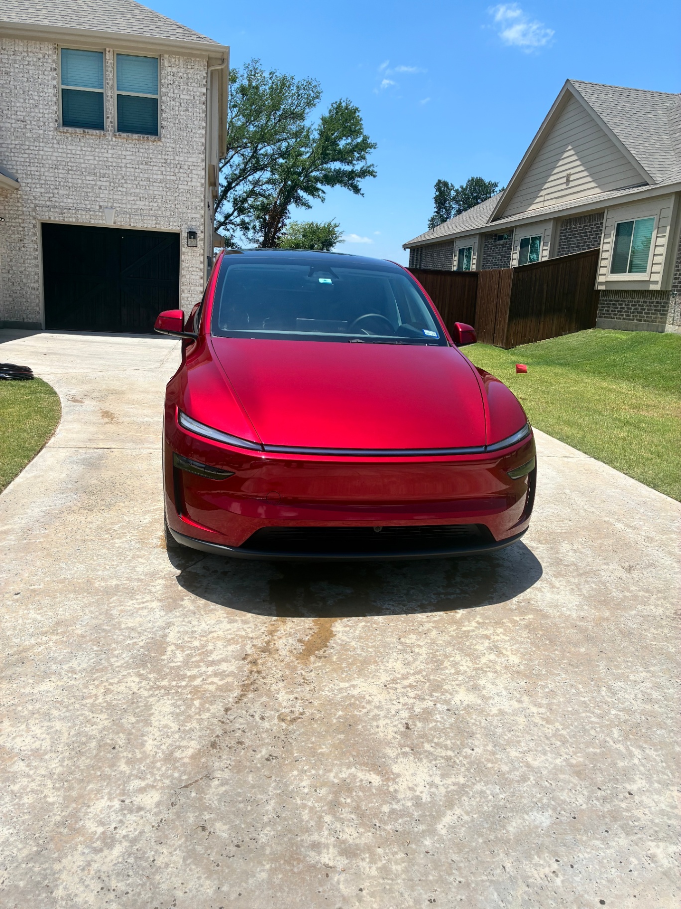 Red Tesla Model Y front view in driveway