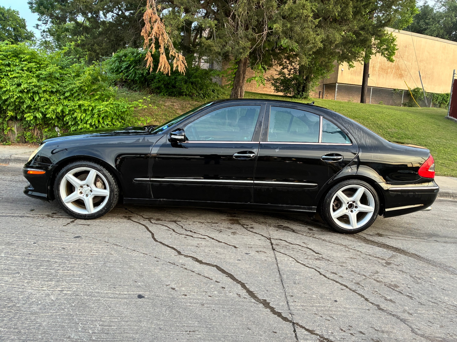 Black Mercedes-Benz sedan side profile